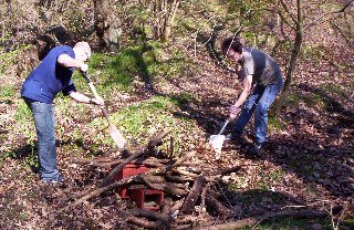 Lee and Jaymie move leaf litter over the logs that everyone has added.