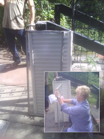 Susan cleans the glass for the solar radiator.